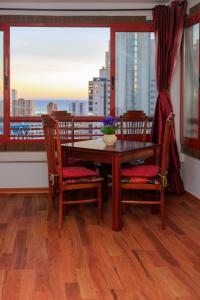 a dining room table and chairs with a view of a city at SUNSHINE Apartament in Benidorm