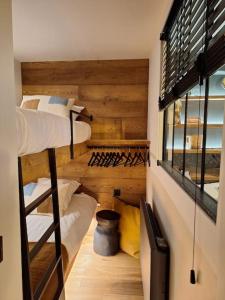 a room with two bunk beds and a window at paisible appartement près des pistes in La Salle Les Alpes +10 photos