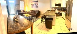 a kitchen and living room with a table and a counter at Sandy Feet Retreat MS in Gulfport