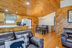 Bryson City Cabin with Private Hot Tub and Pool Table! في بريسون سيتي: غرفة معيشة مع مطبخ وغرفة طعام