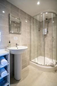 a bathroom with a sink and a shower at The George in Bradford on Avon