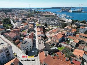 an aerial view of a city with a harbor at Red gold apartment in Pula