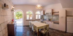 a kitchen with a table with chairs and a dining room at Apartment Curri in Pučišća +34 photos