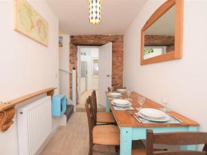 a dining room with a blue table and chairs at 2 bed in Brixham 75549 in Brixham