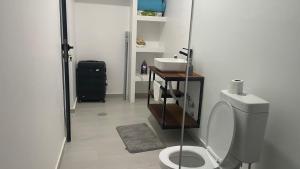 a bathroom with a toilet and a sink at Palmira House in Cidade Velha