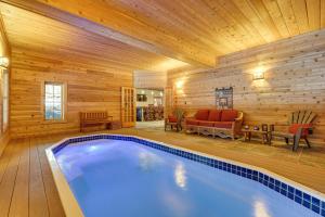 a swimming pool in a room with a wooden wall at Waterfront Old Forge Cabin with Deck and Indoor Pool in Old Forge