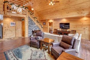 a living room with a couch and chairs and a television at Waterfront Old Forge Cabin with Deck and Indoor Pool in Old Forge