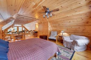 a bedroom with a bed and a ceiling fan at Waterfront Old Forge Cabin with Deck and Indoor Pool in Old Forge