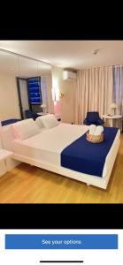 a bedroom with a large white bed with blue sheets at Orbi city Twin Towers in Batumi