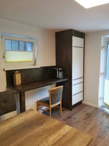 a kitchen with a table and a chair in a room at Apart Desiree in Arzl im Pitztal