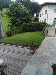 a wooden deck with a pot of flowers on it at Apart Desiree in Arzl im Pitztal