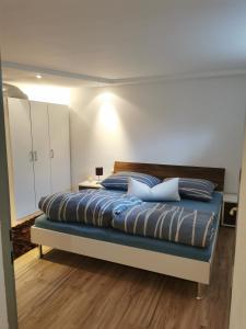a large bed with blue pillows in a bedroom at Apart Desiree in Arzl im Pitztal