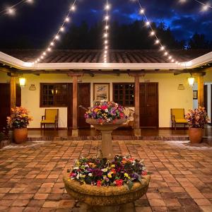 a house with a flower arrangement in front of it at Hotel Evoque Sáchica in Villa de Leyva