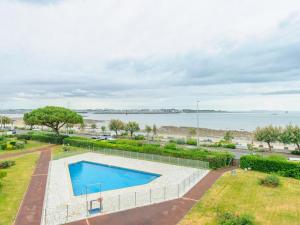 an overhead view of a swimming pool next to the water at ღ La Corniche • Grand Studio, Piscine & Parking in La Rochelle