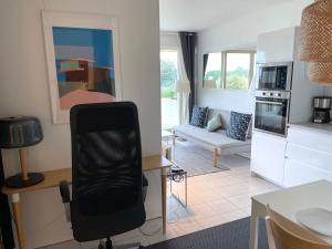 cocina y sala de estar con escritorio y silla en ღ La Corniche • Grand Studio, Piscine & Parking, en La Rochelle