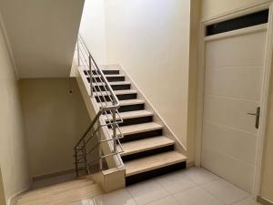 a staircase in a house with a metal railing at Maison vue mer Al Hoceïma in Al Hoceïma