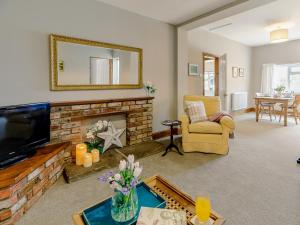 a living room with a fireplace and a mirror at 1 bed property in Easingwold 84002 in Crayke