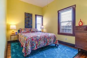 a bedroom with a bed and a dresser and a window at Retro-Inspired Indy Home Walk to Fountain Square! in Indianapolis