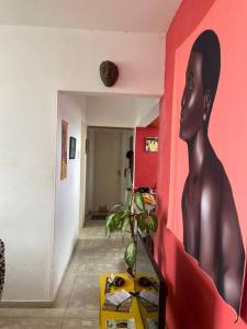 a room with a painting of a man on the wall at Veja o mar no silêncio do centro! Hospede-se no quarto in Recife