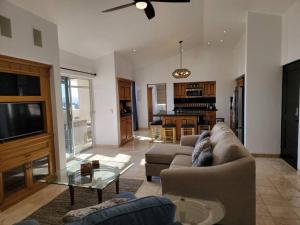 a living room with a couch and a table at Oceanfront Penthouse, 2 Masters, 2 Baths, kitchen! in Cabo San Lucas