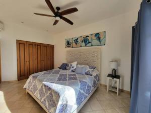 a bedroom with a bed and a ceiling fan at Oceanfront Penthouse, 2 Masters, 2 Baths, kitchen! in Cabo San Lucas +25 photos
