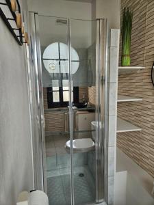 a bathroom with a glass shower with a toilet at Entre 2 flots 2 in Le Tréport