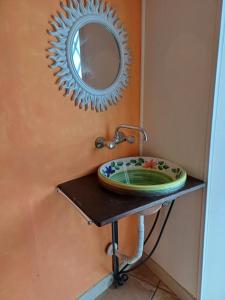 a bathroom with a sink and a mirror on the wall at Etnalcantara in Castiglione di Sicilia