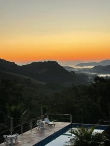 a pool with a view of the mountains at Pousada La Dolce Vita Paraty in Paraty