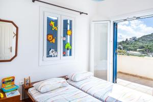 מיטה או מיטות בחדר ב-Villa Zenia Syros