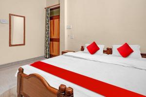 A bed or beds in a room at Hotel Om Residency