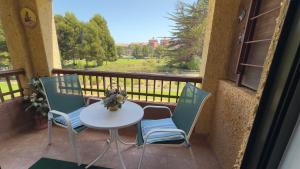 a table and chairs on a balcony with a view at Ilimay Las Cruces in Las Cruces