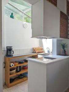 a kitchen with white cabinets and a window at Hermoso dpto San isidro in San Isidro