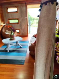 a person standing in a living room with a table at Departamento acogedor in Quellón