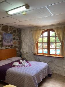 a bedroom with a bed and a window at La Fortaleza De Haro in Puerto Ayora