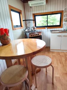 a kitchen with a table and two chairs in a kitchen at Departamento acogedor in Quellón