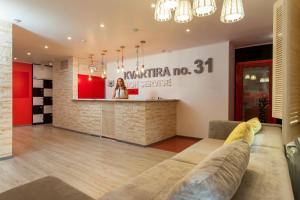 a living room with a couch and a bar at Hostel Kvartira 31 in Belgorod