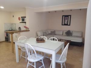 a living room with a table and chairs and a couch at Casa Llao alojamiento de montaña in San Carlos de Bariloche