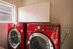 a red washer and dryer in a room at Guadalupe River Getaway - 140 Feet of Beautiful Waterfront! in New Braunfels