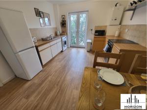 a kitchen with a dining table and a refrigerator at FREE Parking-Waterfront- Victoria Dock-Siemens-Contractors-Relocators in Hull