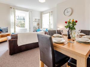 a dining room and living room with a table and chairs at 3 Bed in Edinburgh 79550 in Kirknewton