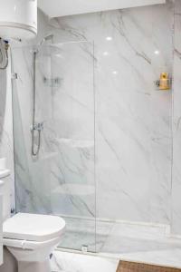 a bathroom with a glass shower with a toilet at Cozy & Brand New Flat In Casablanca in Casablanca