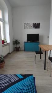 a living room with a table and a blue cabinet at Ferienwohnung Dahme Berlin am Wasser in Berlin