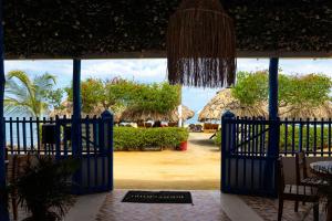 a gate to a resort with a view of the ocean at Hotel Costa Mar Coveñas in Coveñas