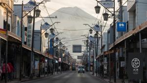 an empty city street with a mountain in the background at Oike Hotel in Fujikawaguchiko
