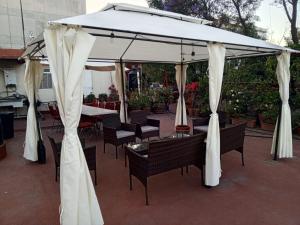 a white canopy with tables and chairs under it at Mejor precio ubicación 2p habitación cómoda in Mexico City