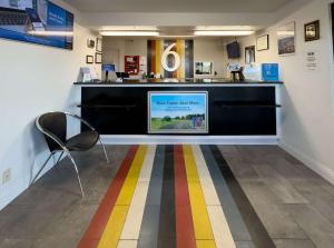 a lobby with a colorful striped floor in a store at Motel 6-Janesville, WI in Janesville