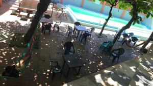 a group of chairs and tables next to a swimming pool at Longboard Hotel in La Libertad