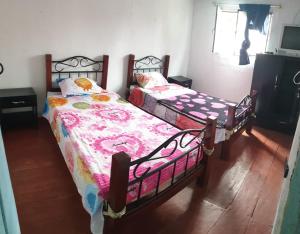 Postel nebo postele na pokoji v ubytování Hostal Perla Del Norte