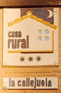 a sign for a hotel with a building on it at Casa Rural La Callejuela in Ayllón