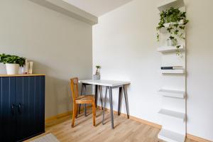 a dining room with a table and a chair at Do Well Messe in Basel